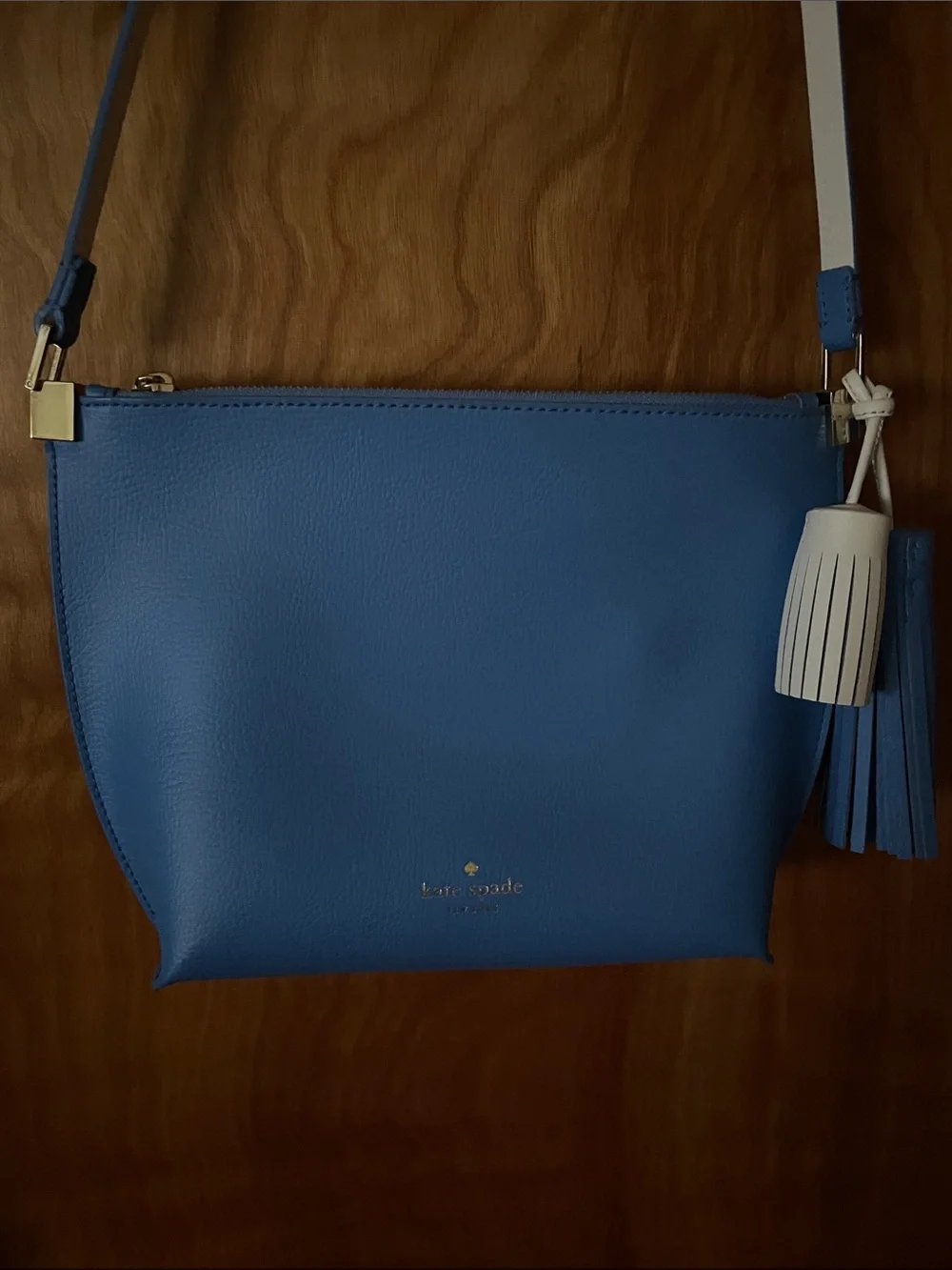 kate spade blue crossbody with cream strap and tassel